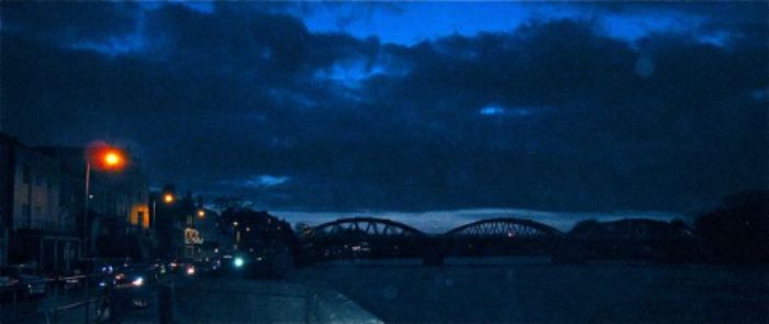 Indigo sky by the river with Barnes Bridge 