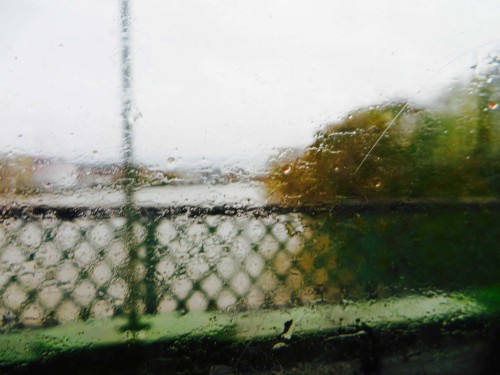 View of Hammersmith Bridge in driving rain from 209 bus ...